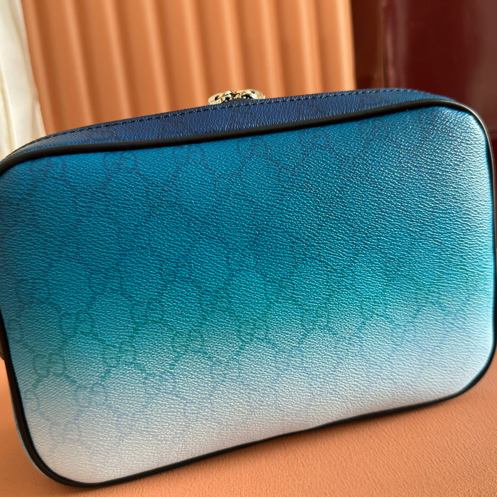 Gucci bag exterior with blue-to-light gradient panels, structured rounded shape, zipper top