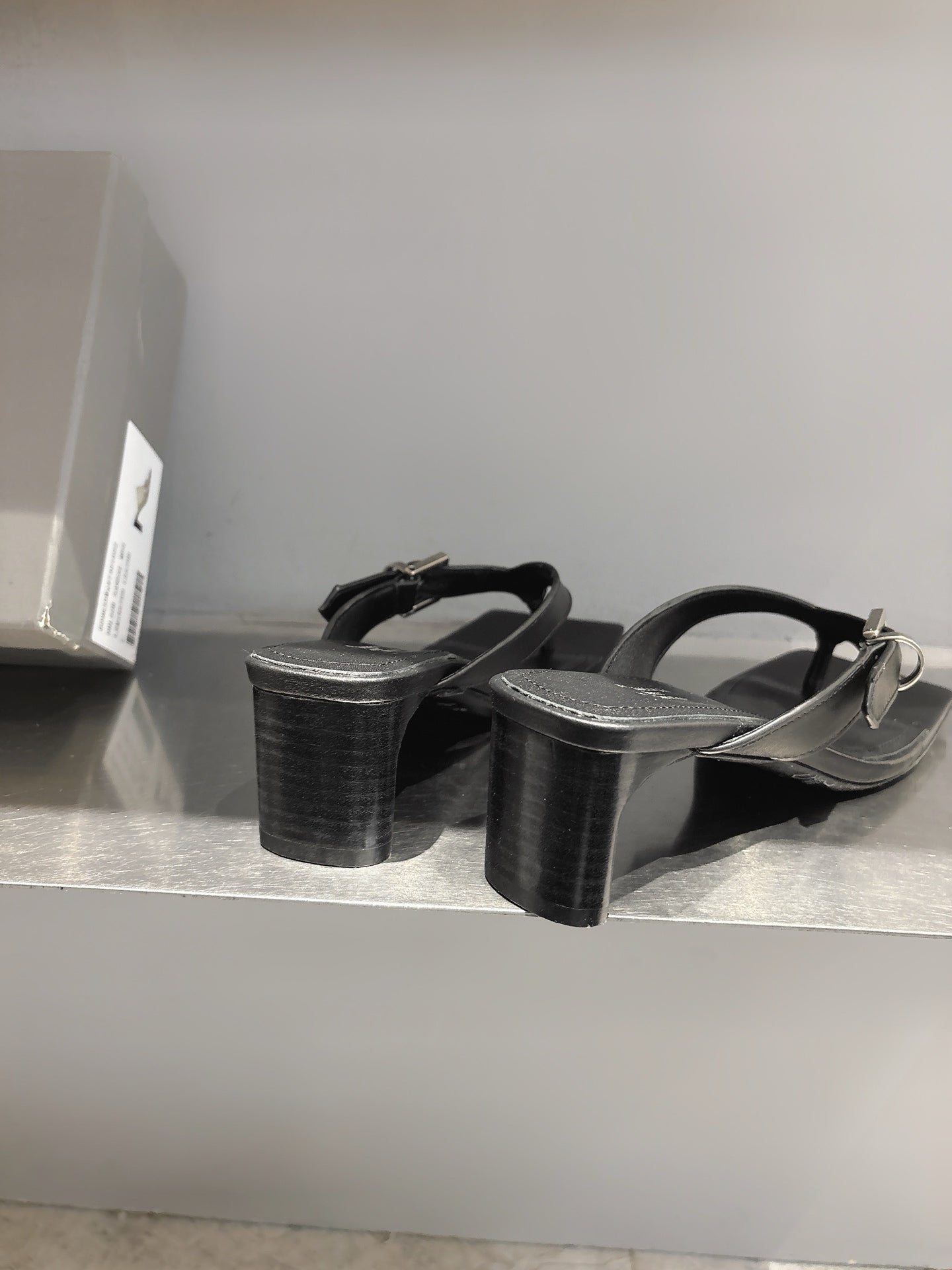 Balenciaga black leather sandals with thick block heels and buckle straps, side view