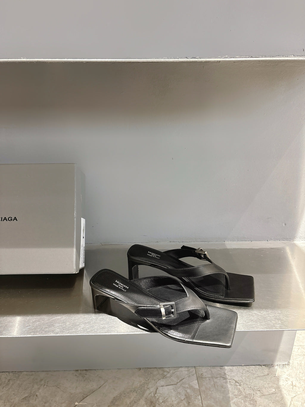 Balenciaga black leather sandals with buckle straps and flat square toe, side view