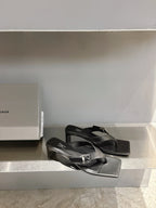 Balenciaga black leather sandals with buckle straps and flat square toe, side view