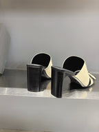 Balenciaga cream slide sandals with textured black block heels and open backs