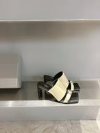 Balenciaga cream slide sandals with black toe strap and chunky block heel