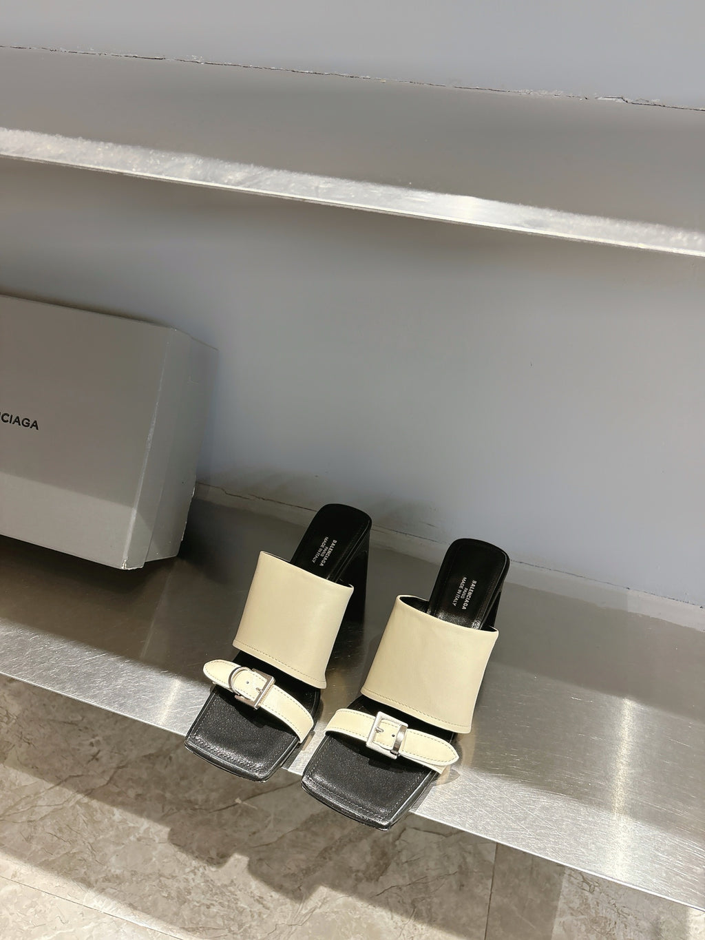 Balenciaga cream and black slide sandals with tall block heels and front buckles