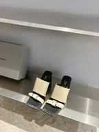 Balenciaga cream and black slide sandals with tall block heels and front buckles