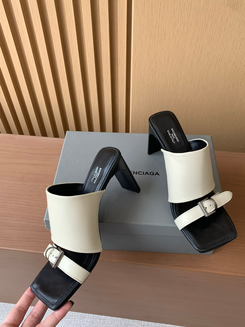 Balenciaga heeled sandals with cream strap, silver buckle, and black sole