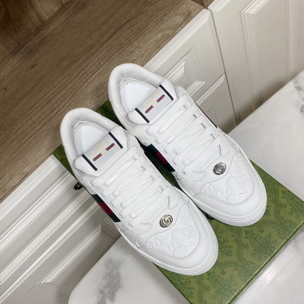 Pair of white Gucci sneakers with green-red web stripes, lace-up and round toe.