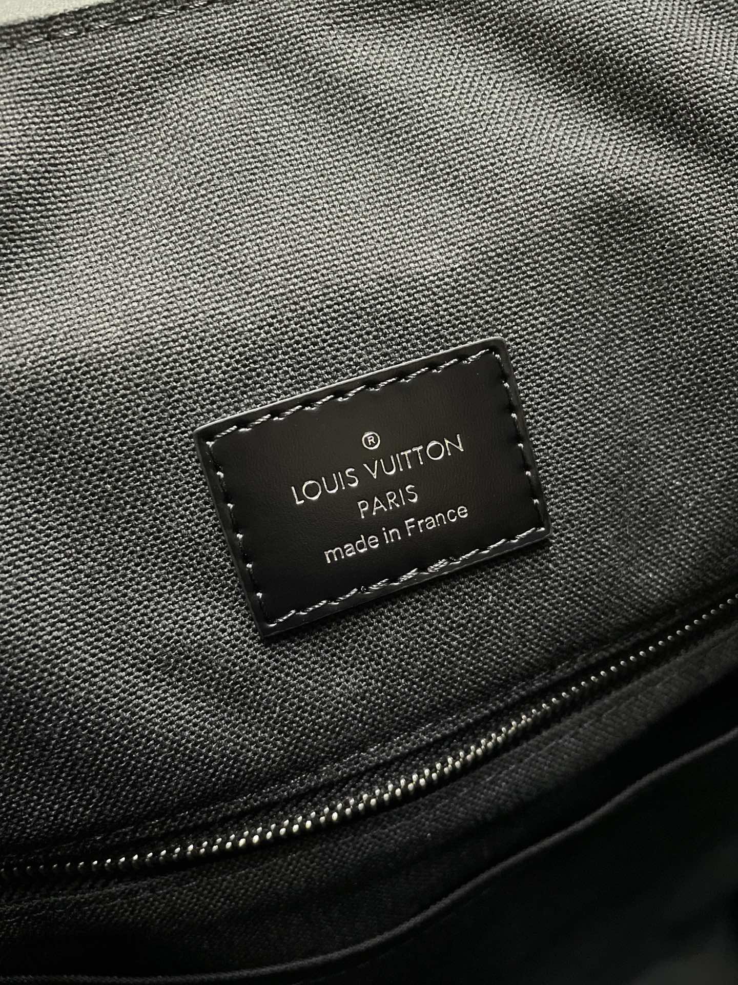 Louis Vuitton made in France authenticity label on textured bag interior