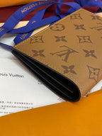 Small bag with tan monogram exterior, opened showing dark interior.