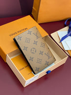 Small bag with dark monogram pattern, shown in open box with logo label.