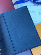 Small bag with textured navy exterior and stitched edges, close-up view.