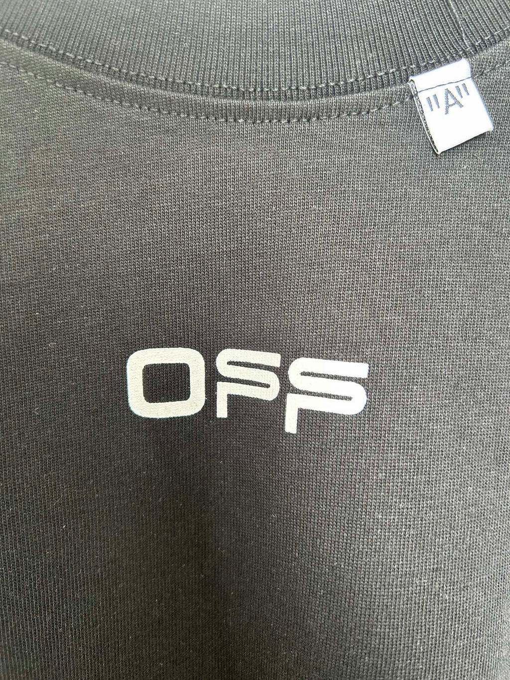 Off White OFFS logo screen print on dark T-shirt fabric