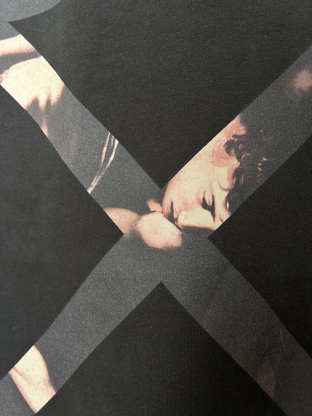 Off White black T-shirt close-up of dark X graphic over photo print