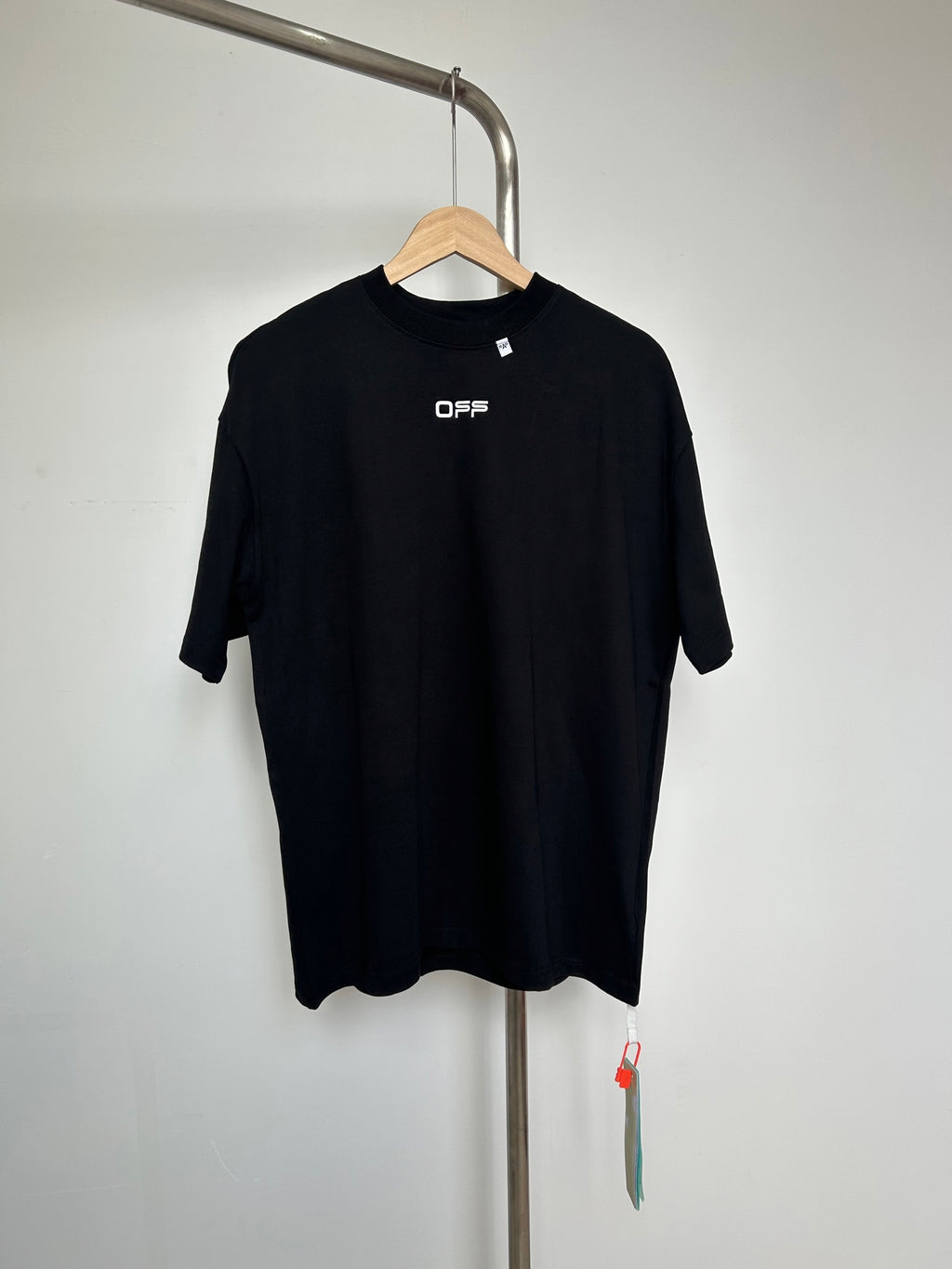 Off White black graphic T-shirt on hanger, OFFS logo at chest