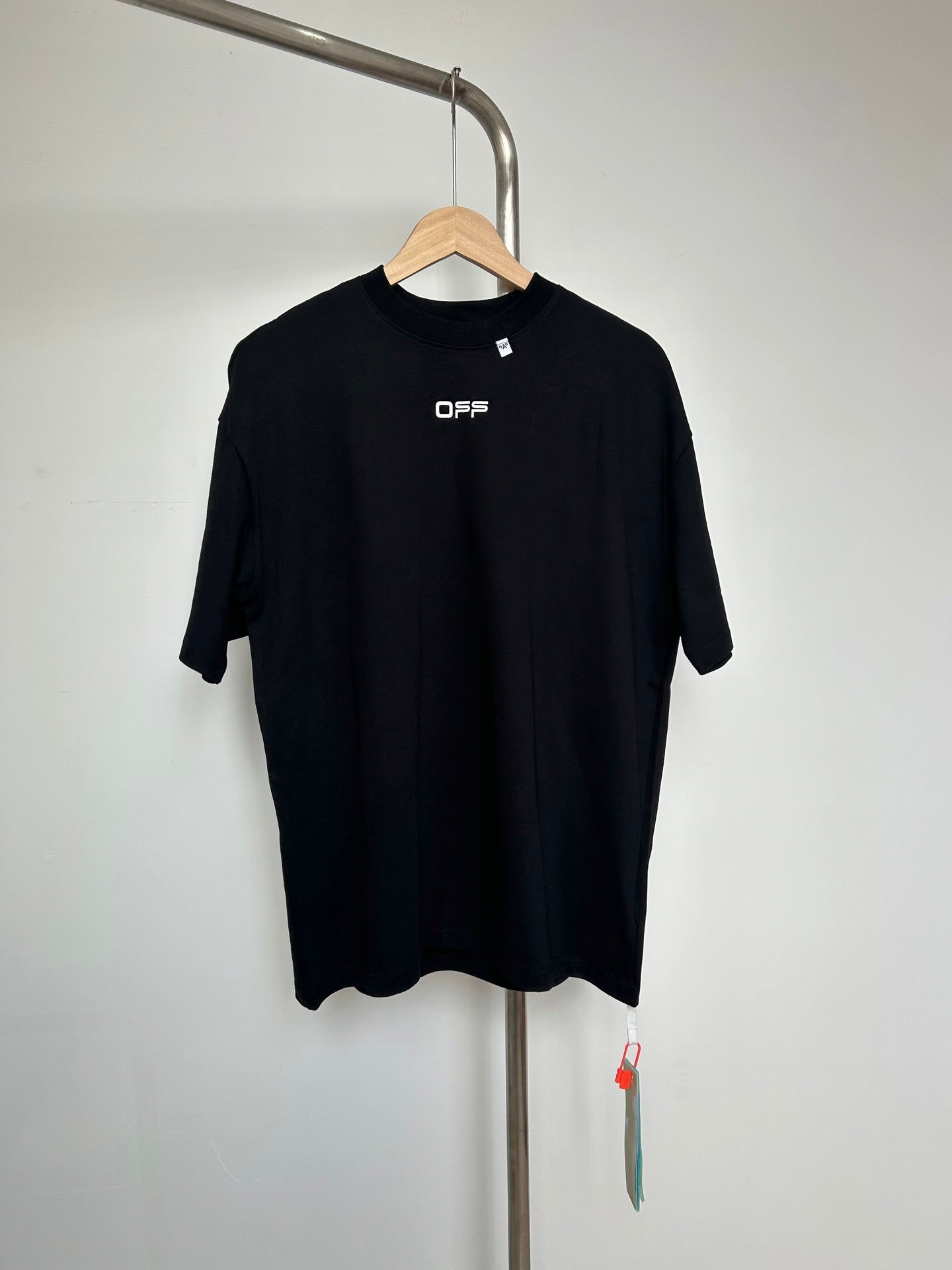 Off White black graphic T-shirt on hanger, OFFS logo at chest