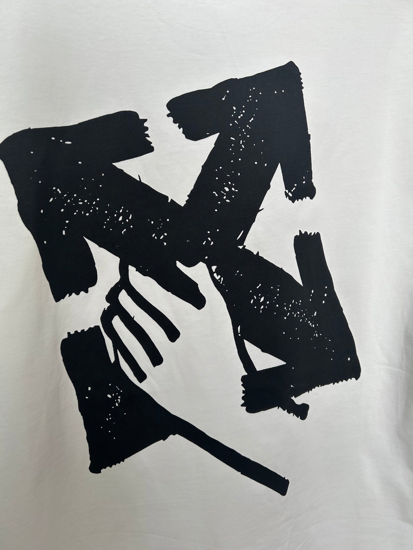 Off-white T-shirt close-up of large black graphic hands illustration