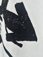 Off-white T-shirt close-up of large black graphic and speckled texture
