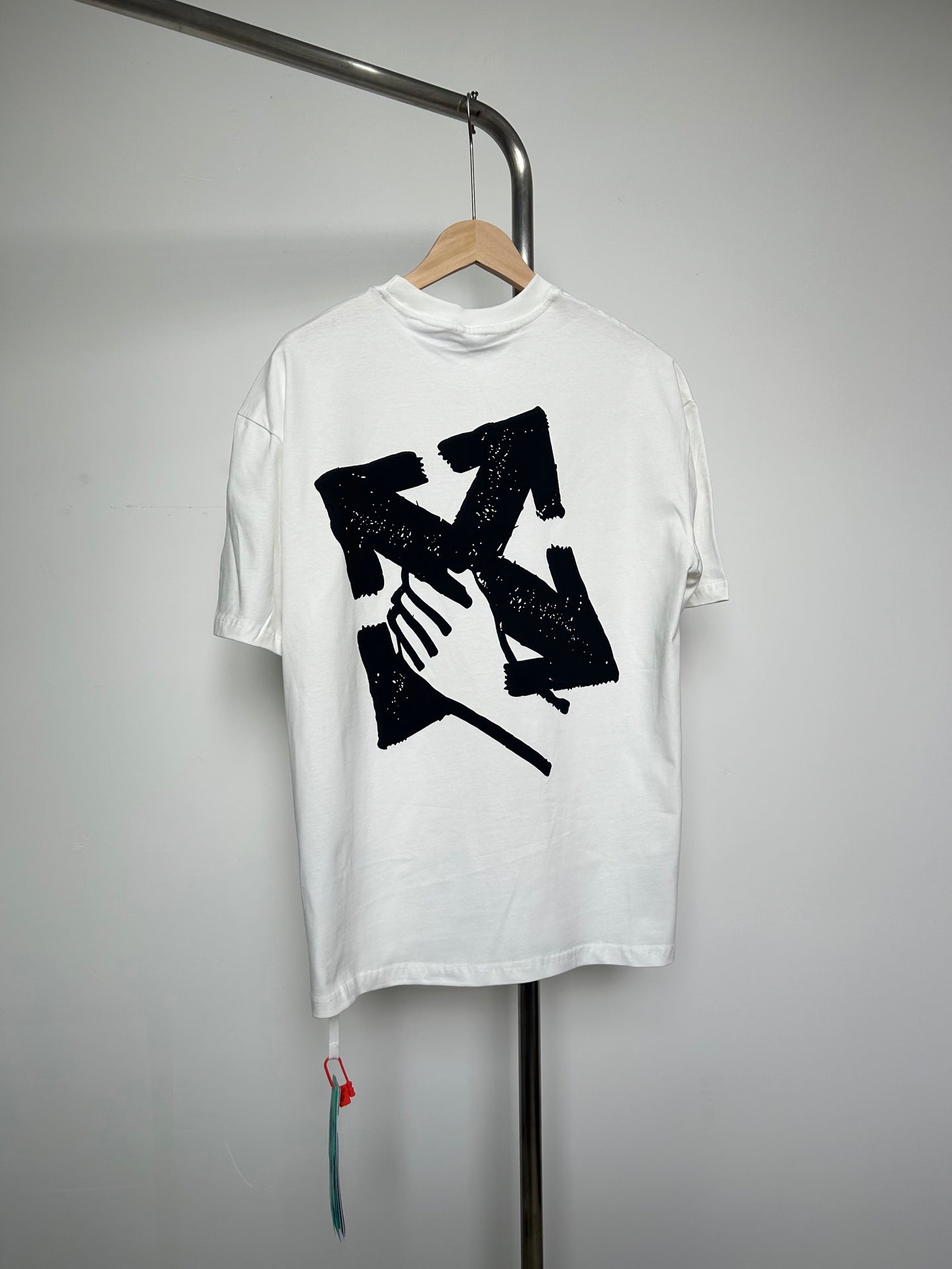 Off-white T-shirt with large black graphic illustration on front