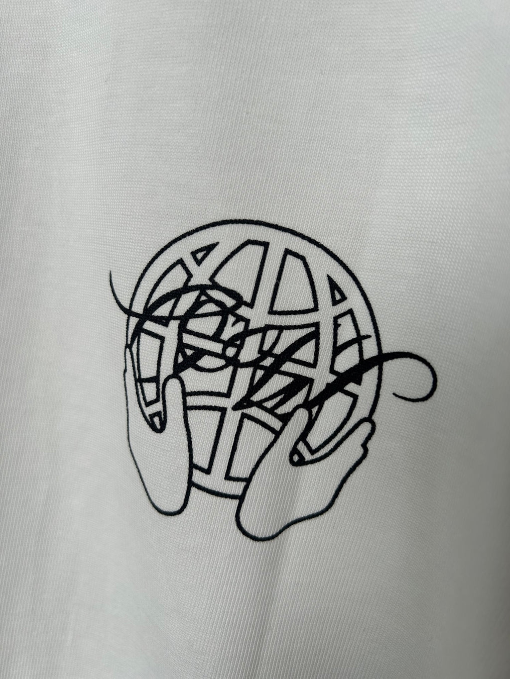 Off-white T-shirt close-up of black line-art graphic on chest