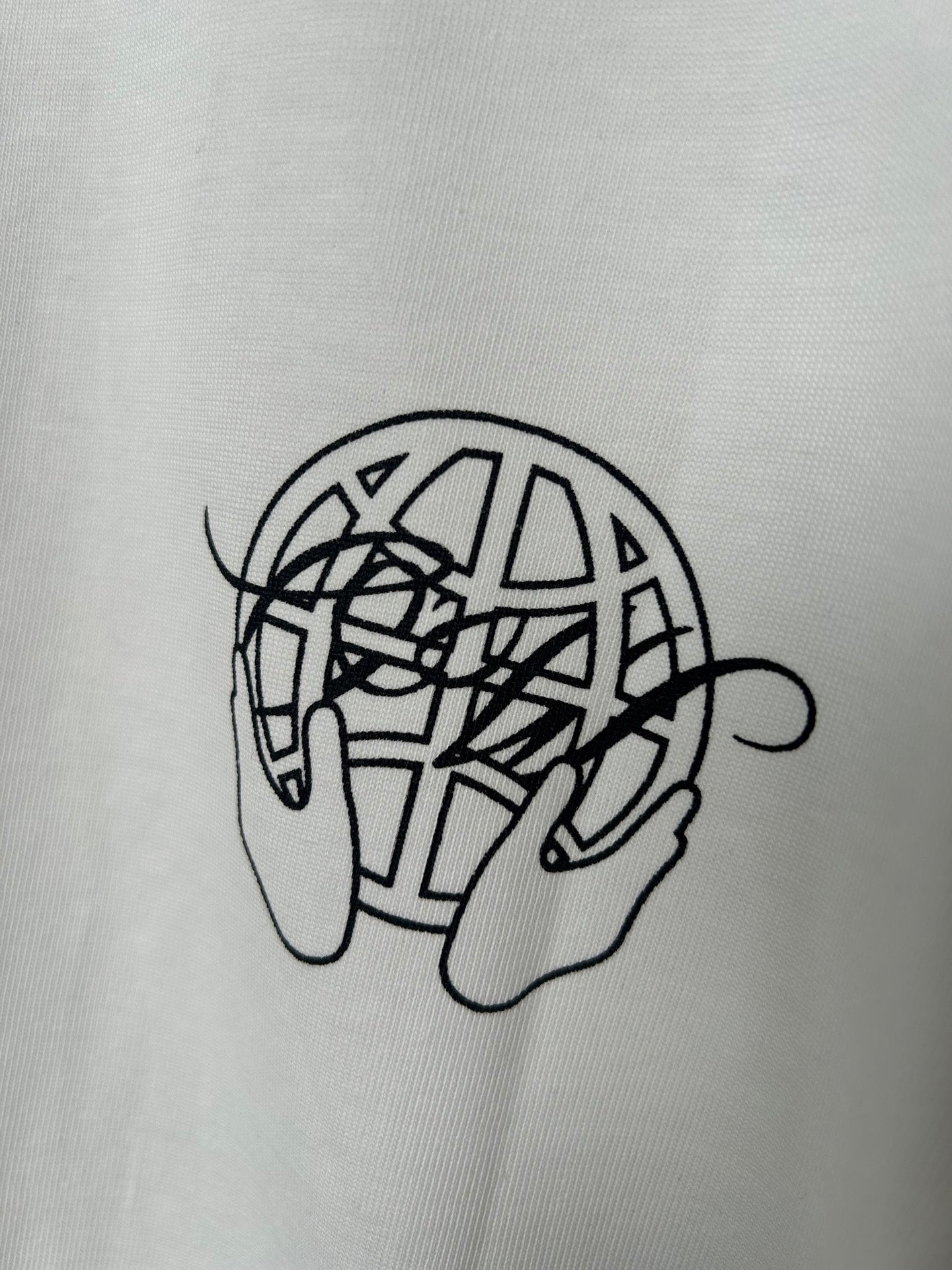Off-white T-shirt close-up of black line-art graphic on chest
