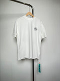 Off-white T-shirt with small black graphic logo at left chest