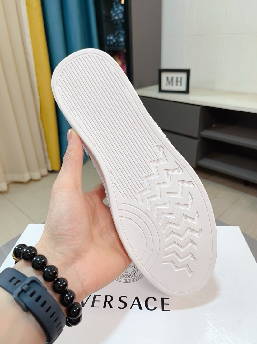 White luxury sneaker outsole with zigzag tread pattern on the rubber sole.