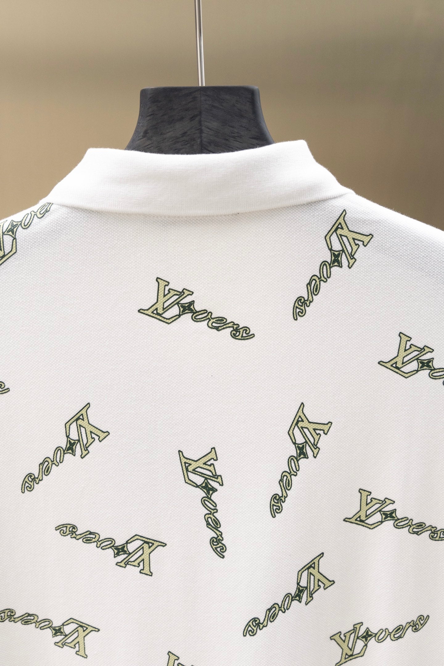 White polo shirt back with high collar and repeating Louis Vuitton-style logo print