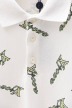 White polo shirt button placket and collar with Louis Vuitton-style logo print