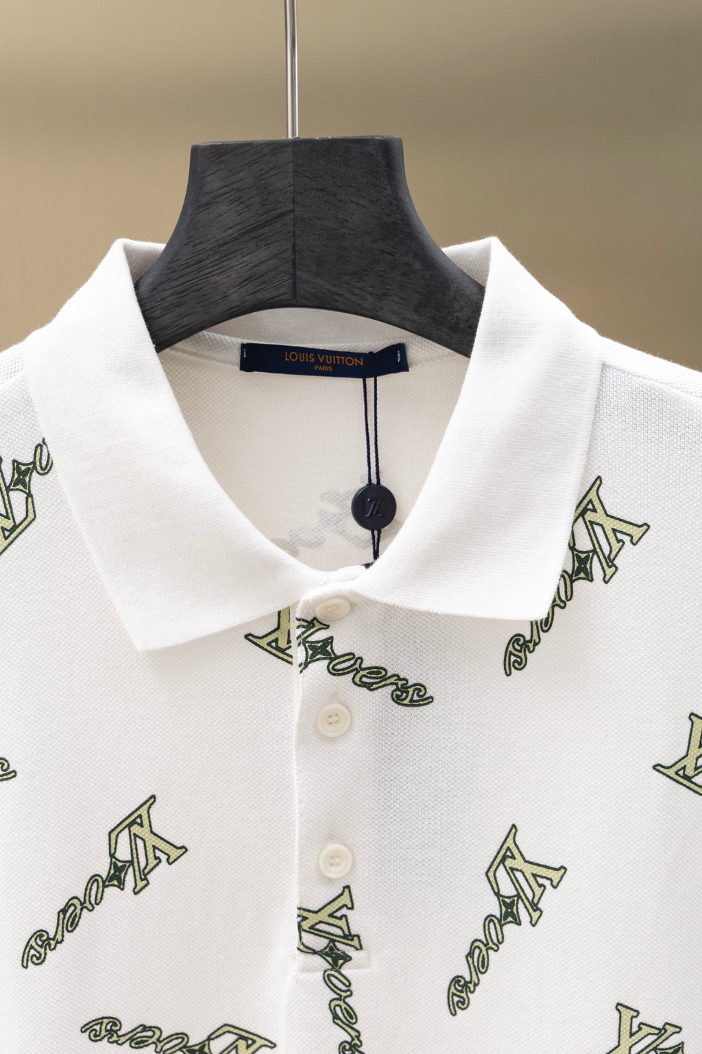 White polo shirt neckline with button placket and Louis Vuitton-style logo print