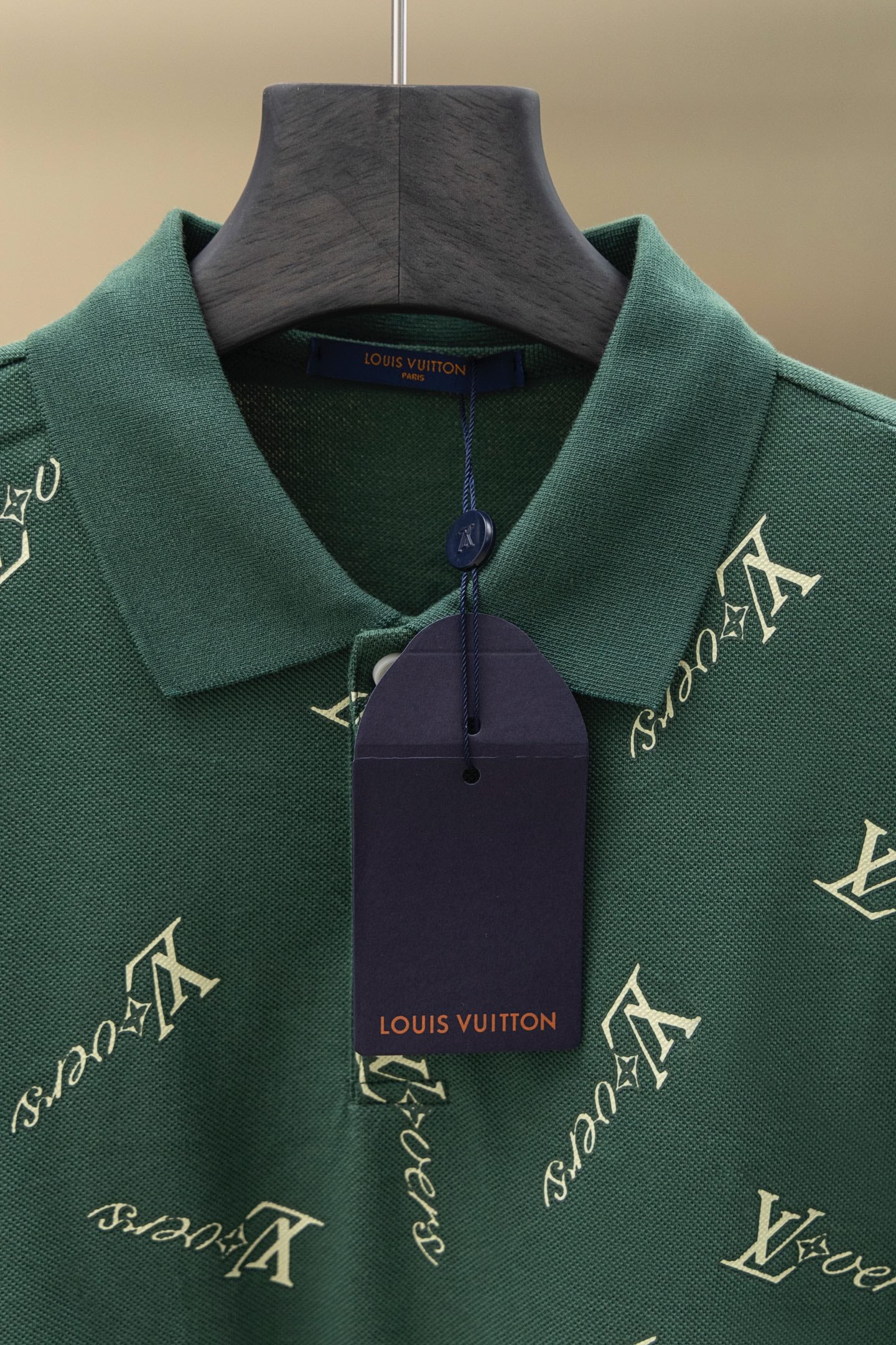 Louis Vuitton polo shirt front in dark green with repeating logo pattern and button placket