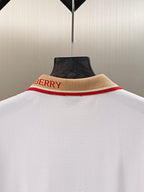 Burberry polo shirt collar close-up with tan band and red “BURBERRY” lettering