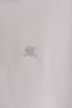 Burberry polo shirt fabric close-up with small embossed horse logo