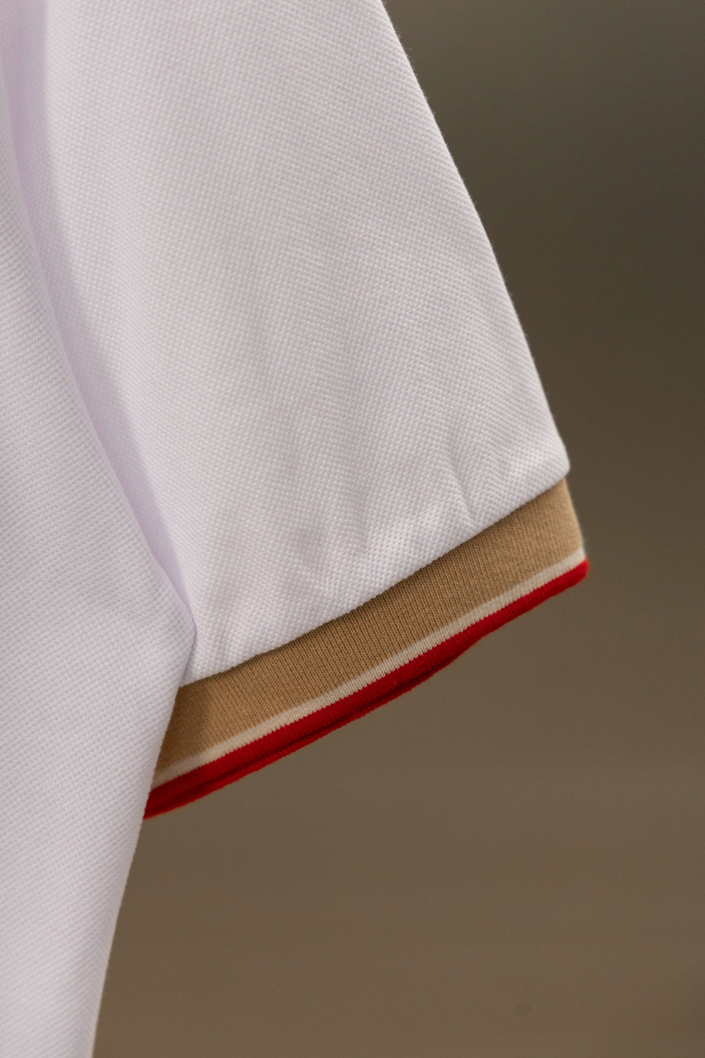 Burberry polo shirt sleeve hem with tan stripe and red edge trim