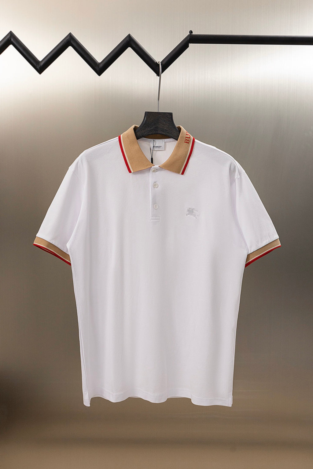 Burberry white polo shirt with button placket and tan collar in red trim