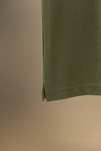 Burberry polo shirt hem on olive green fabric