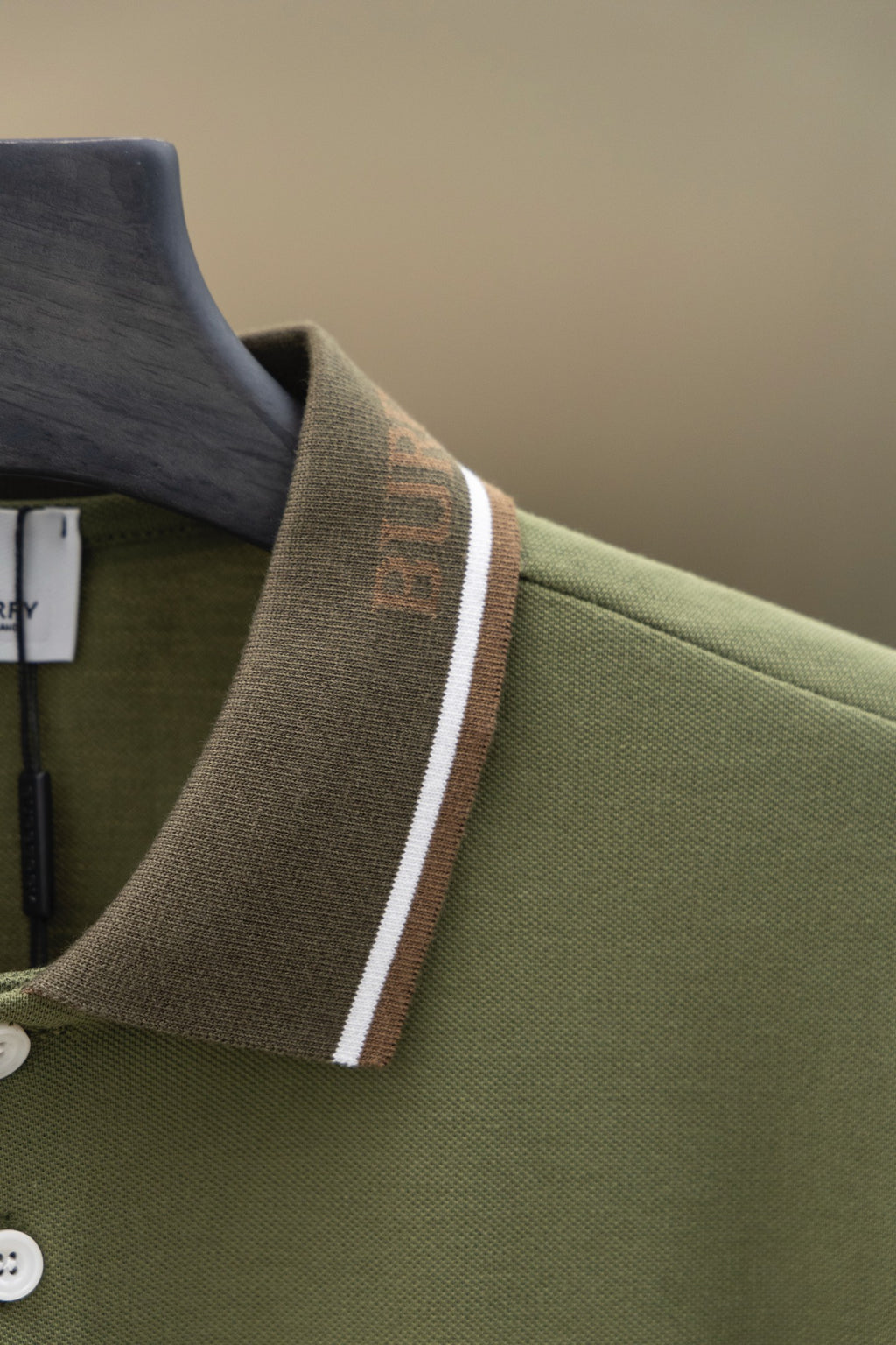 Burberry polo shirt shoulder and collar detail with striped trim and button placket