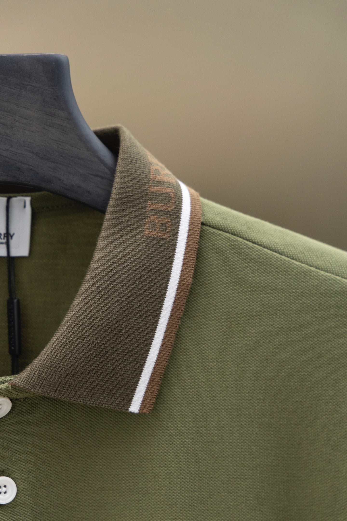 Burberry polo shirt shoulder and collar detail with striped trim and button placket