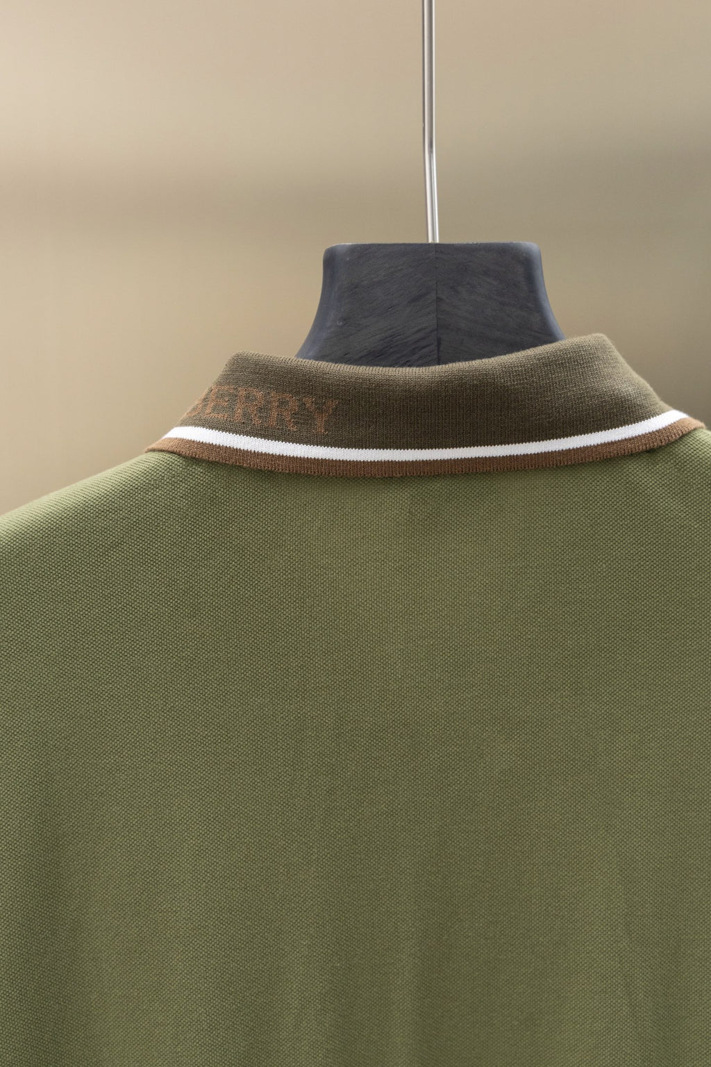 Burberry polo shirt neckline close-up with ribbed collar and striped trim