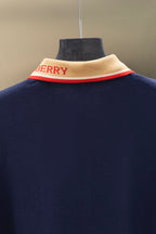 Navy polo shirt back collar detail with beige band and red stripe