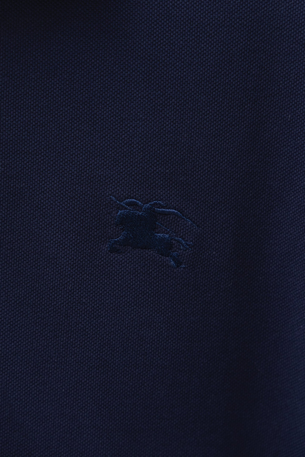 Navy polo shirt chest logo embroidery detail