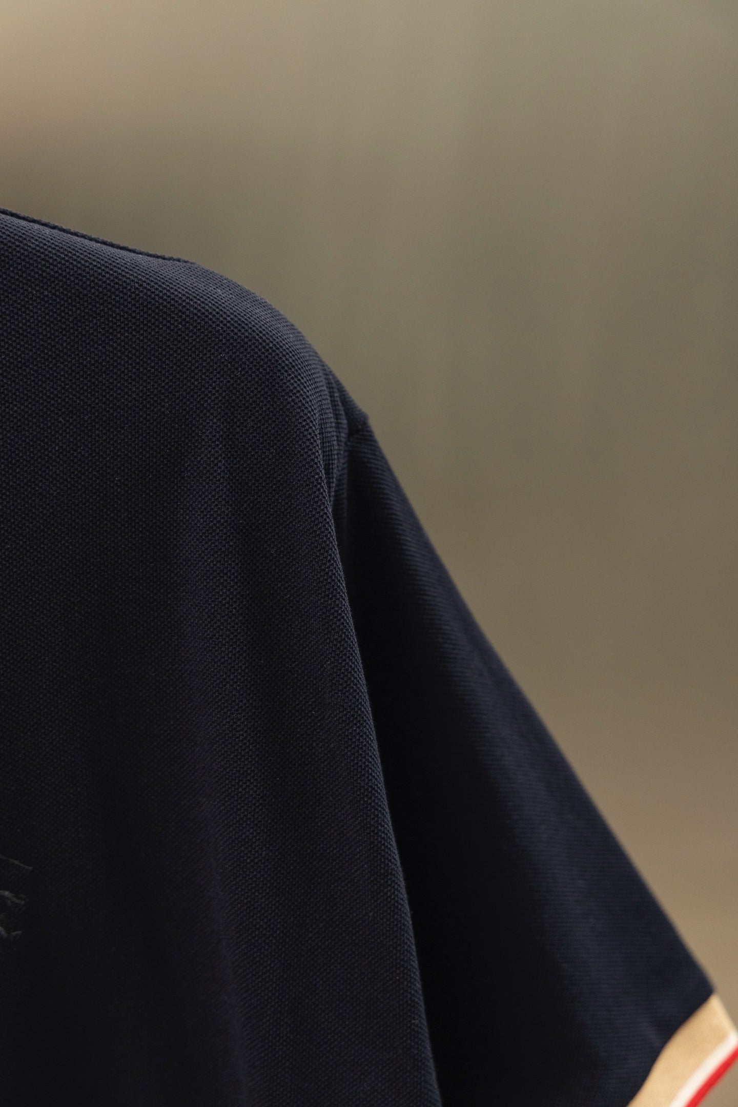 Burberry navy polo shirt fabric texture and curved shoulder seam