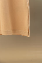 Light beige polo shirt hem detail with clean straight bottom edge