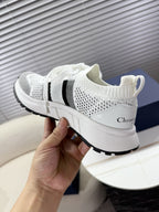 White mesh unisex sneakers with black logo stripe and black-trimmed sole