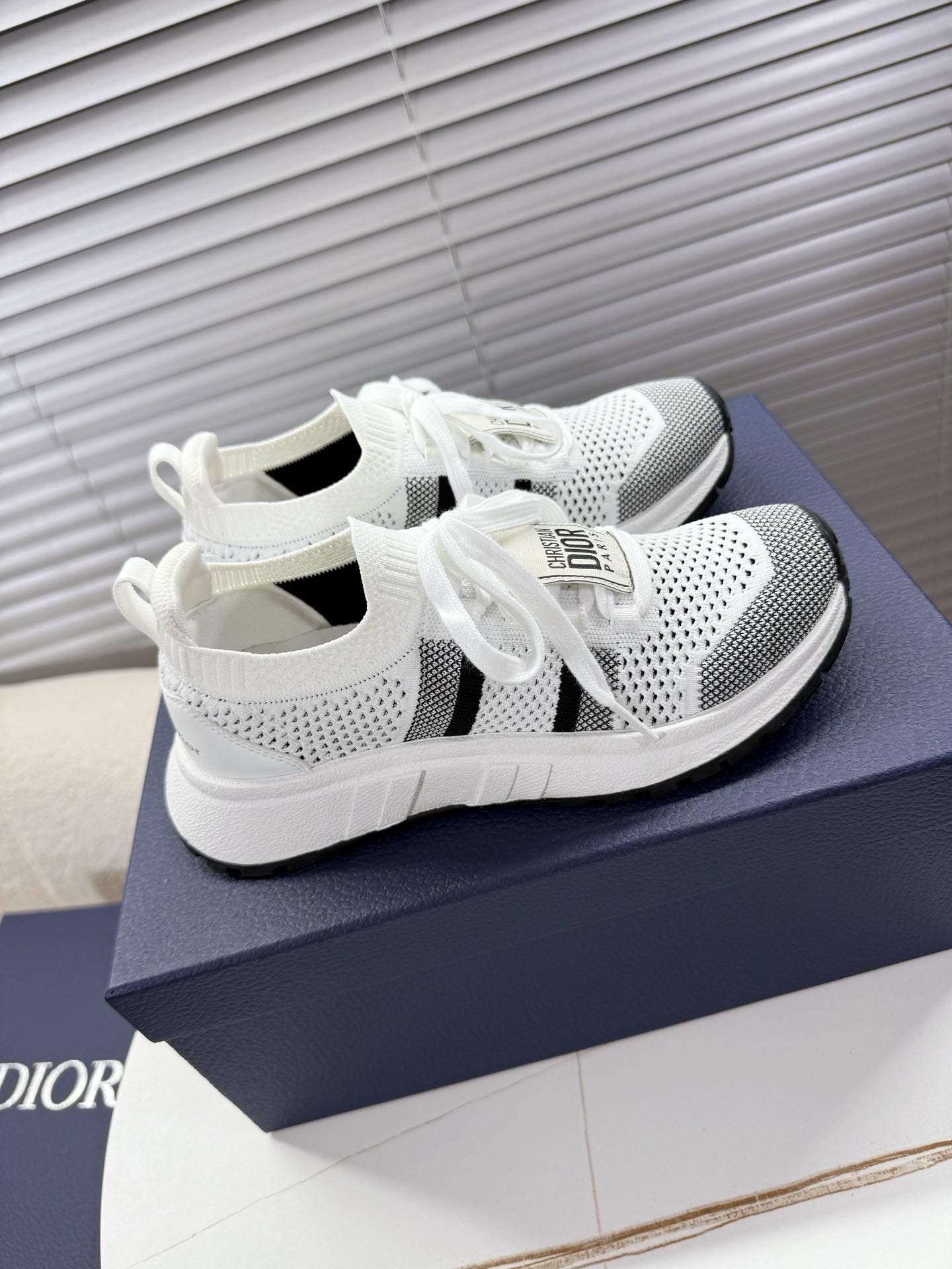 White mesh unisex sneakers with black side stripe and lace-up front