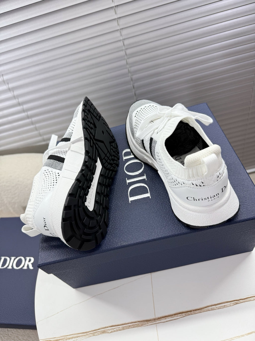 White and black unisex sneakers with mesh upper and black heel panel