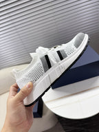 White mesh unisex sneakers with black side stripes and thick white midsole