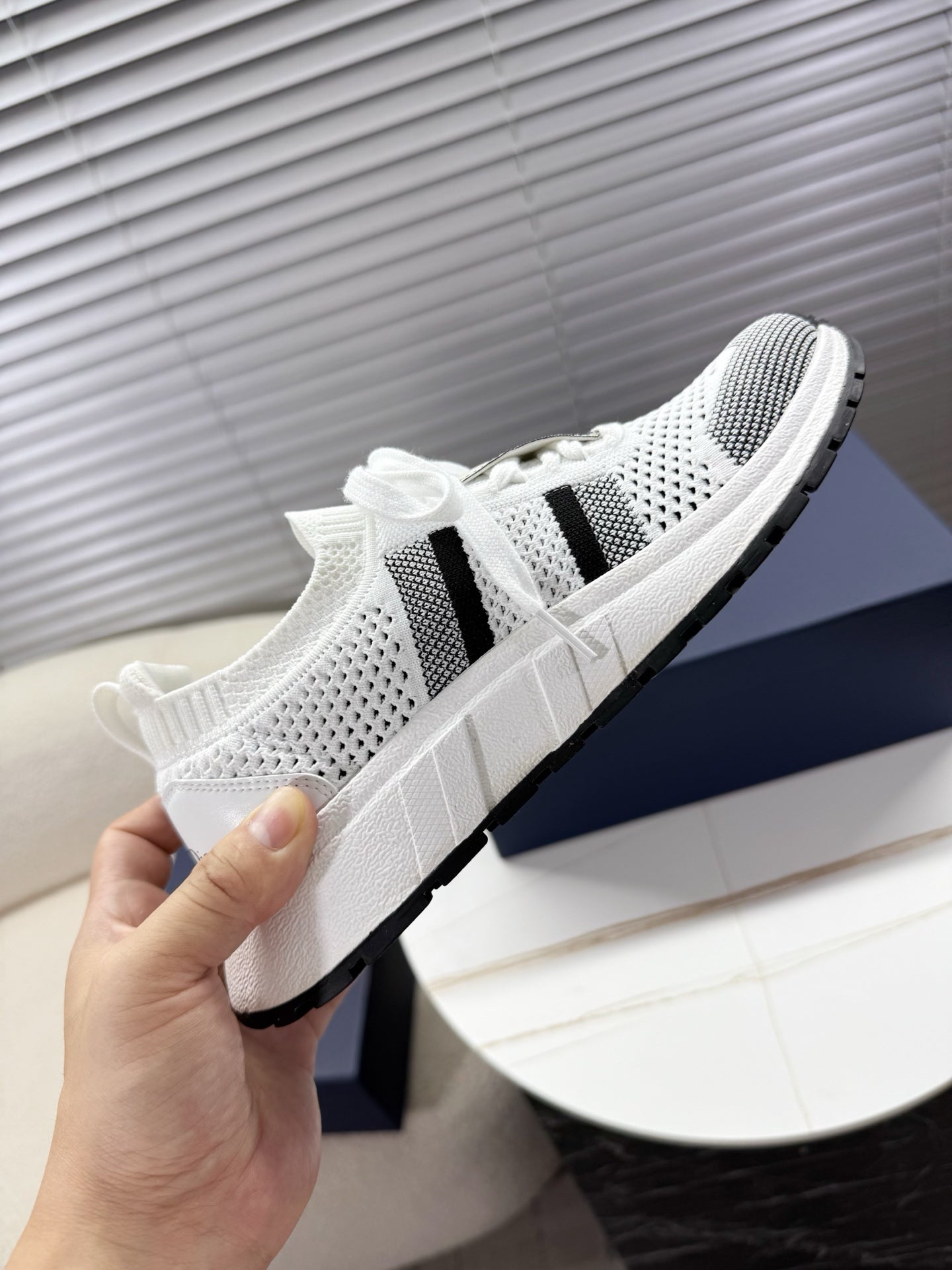 White mesh unisex sneakers with black side stripes and thick white midsole