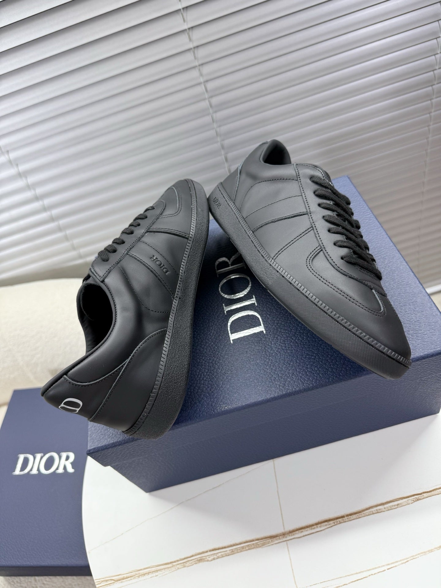 Dior gray leather sneakers, lace-up with side stripe panels and logo.