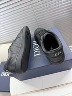 Dior gray leather sneakers with open heel showing black interior and Dior logo.