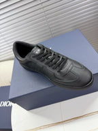 Dior dark leather sneaker with lace-up, side logo and smooth toe panel.