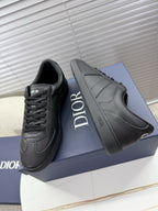 Dior gray leather sneakers with lace-up and bold side logo detailing.